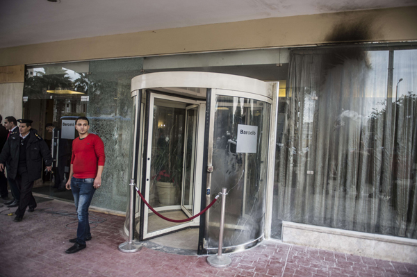 Egyptian security forces (left) stand at the entrance of the Three Pyramids Hotel in Cairo’s Al Haram district on Thursday (AFP photo)